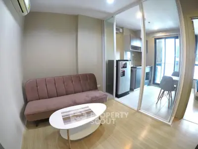 Modern living room with glass partition and compact kitchen in a stylish apartment