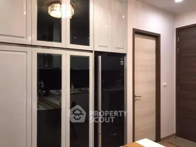 Modern kitchen with sleek cabinetry and stylish lighting