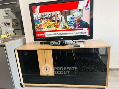 Modern living room with sleek TV stand and kitchen view, perfect for contemporary urban living.
