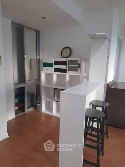 Modern interior with stylish shelving and bar stools in a cozy living space