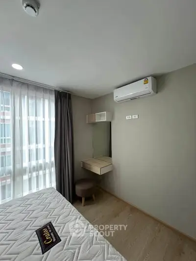 Modern bedroom with air conditioning and natural light from large window