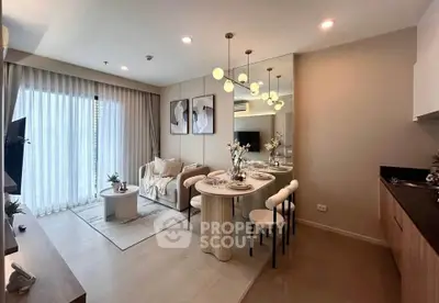 Modern open-plan living and dining area with elegant decor and natural light.