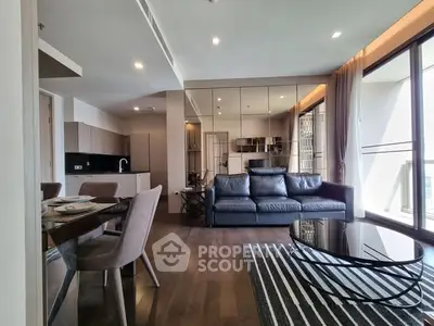 Modern living room with sleek furniture and open kitchen layout in luxury apartment