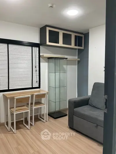 Cozy study room with modern furniture and ample natural light.