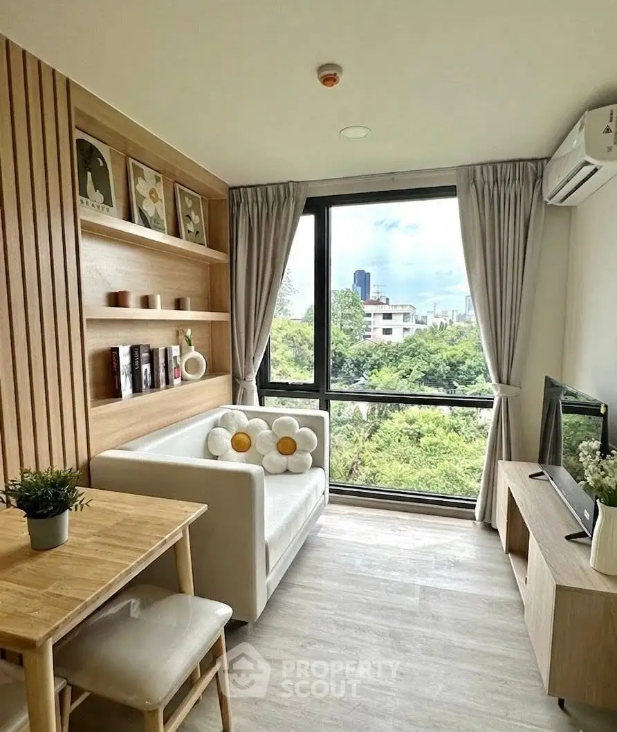 Charming living room with scenic view, modern decor, and cozy seating in a high-rise apartment.