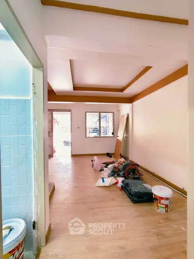 Spacious living room with wooden flooring and modern ceiling design, ready for customization.