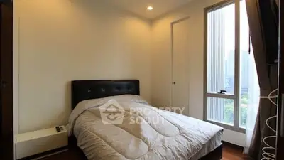 Cozy bedroom with city view and modern furnishings