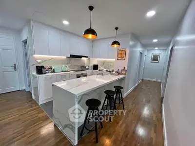 Modern kitchen with sleek white cabinetry and stylish breakfast bar