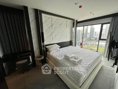 Luxurious bedroom with city view in modern high-rise apartment