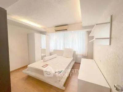 Spacious bedroom with modern design and ample natural light