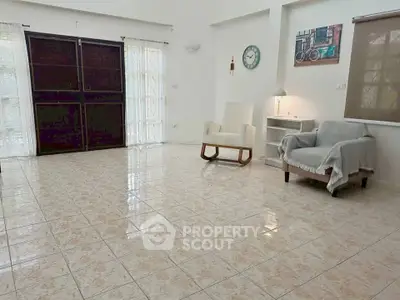 Spacious living room with tiled floor and cozy seating area