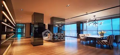 Luxurious open-plan living and dining area with modern lighting and floor-to-ceiling windows.