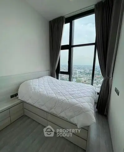 Modern bedroom with large window offering stunning city view, featuring sleek design and cozy ambiance.