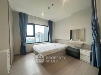 Modern bedroom with large window and stylish decor in high-rise apartment