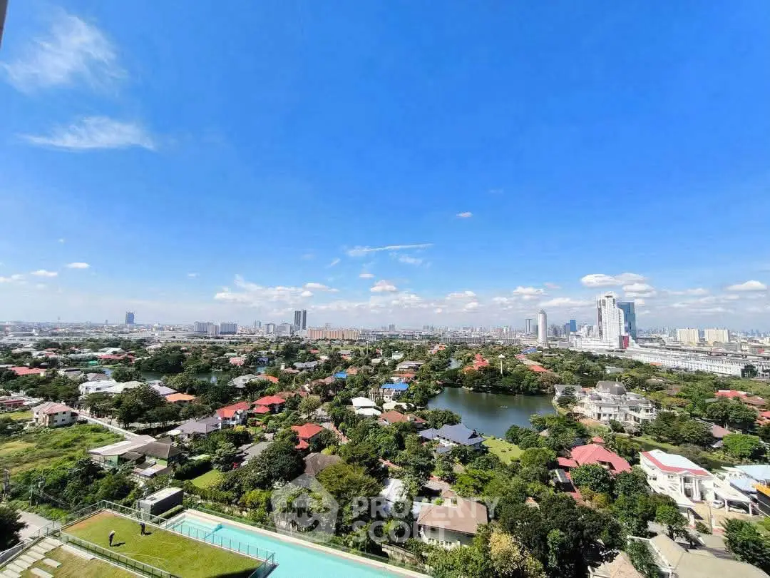 Stunning cityscape view from high-rise building with lush greenery and skyline.