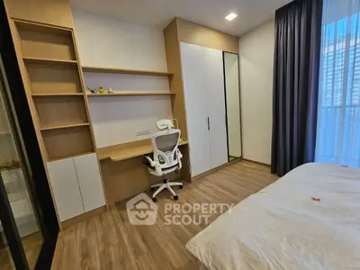 Modern bedroom with built-in study desk and large window for natural light