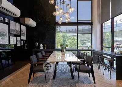 Modern dining area with large windows and stylish lighting in a contemporary home.