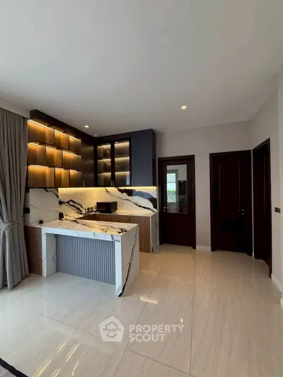 Luxurious modern kitchen with marble countertops and sleek cabinetry in a stylish apartment.