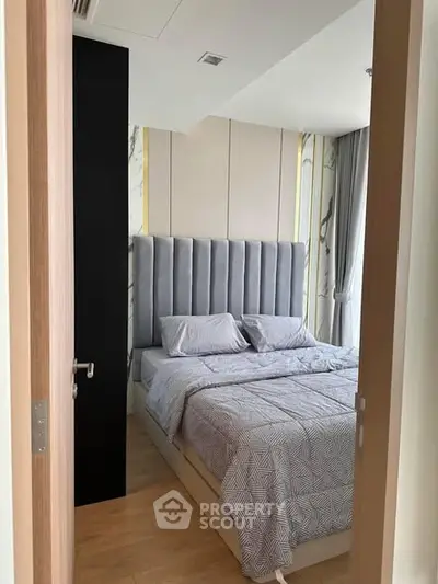 Modern bedroom with stylish decor and cozy bedding in a contemporary apartment.