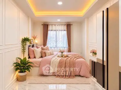 Luxurious bedroom with elegant decor and soft lighting, featuring a cozy bed and stylish furnishings.
