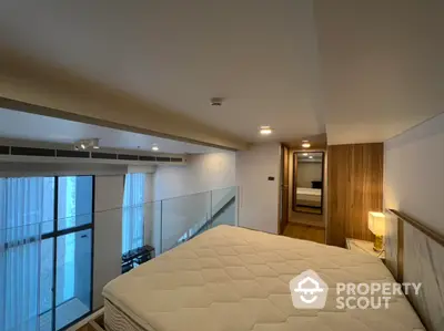 Spacious bedroom with modern design, featuring a large bed, sleek wood paneling, and ample natural light from floor-to-ceiling windows leading to a balcony.