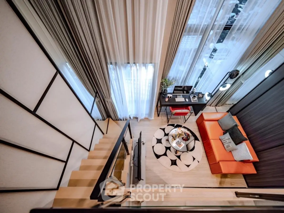 Modern loft-style living room with high ceilings and stylish decor