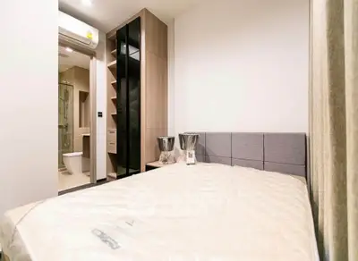 Modern bedroom with ensuite bathroom and stylish storage solutions
