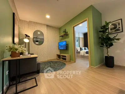 Modern living room with stylish decor and view into cozy bedroom