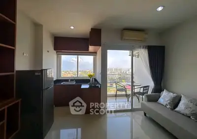 Modern apartment with open kitchen and balcony offering stunning city views.