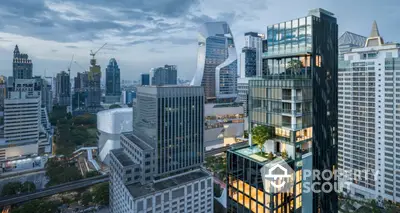 Stunning cityscape view of modern high-rise buildings with lush rooftop garden at dusk.