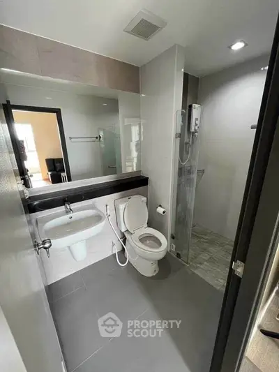 Modern bathroom with sleek fixtures and glass shower enclosure