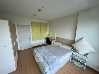 Spacious bedroom with modern decor and natural light, featuring a comfortable bed and stylish furnishings.