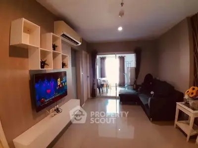 Modern living room with sleek TV setup and cozy seating area