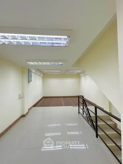 Spacious interior with modern lighting and sleek flooring, ideal for versatile use.