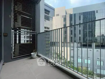 Modern apartment balcony with city view and sleek railing design.