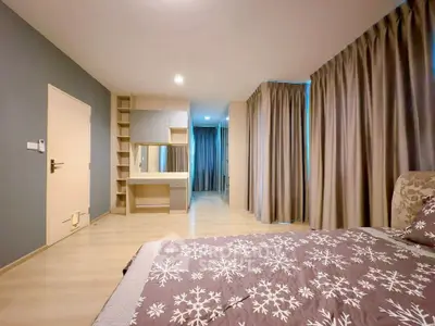 Spacious bedroom with modern decor and ample natural light