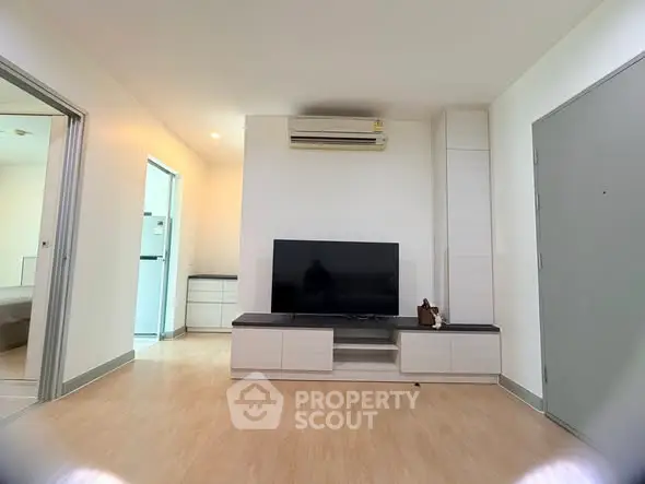 Modern living room with sleek TV setup and air conditioning