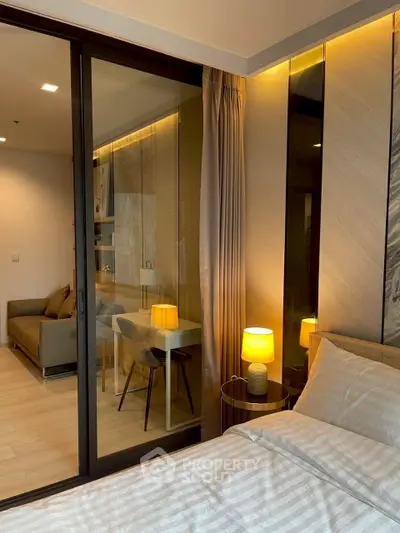 Modern bedroom with glass partition and cozy lighting in luxury apartment