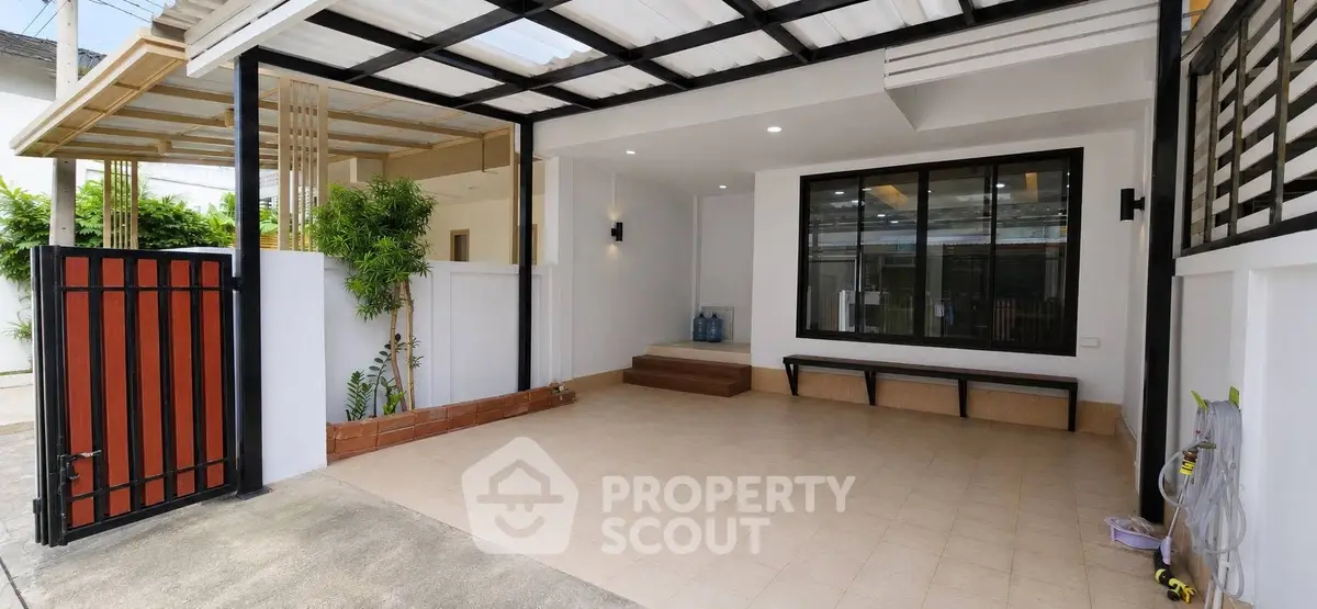 Modern home entrance with spacious covered parking and stylish design.