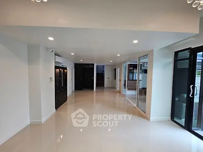 Spacious modern living room with sleek tile flooring and large windows