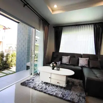 Stylish living room with modern sofa and large windows opening to a garden view.