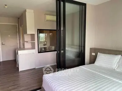 Modern studio apartment with glass partition and in-unit washer