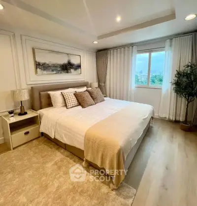 Luxurious bedroom with elegant decor and city view, featuring a cozy king-size bed and stylish furnishings.