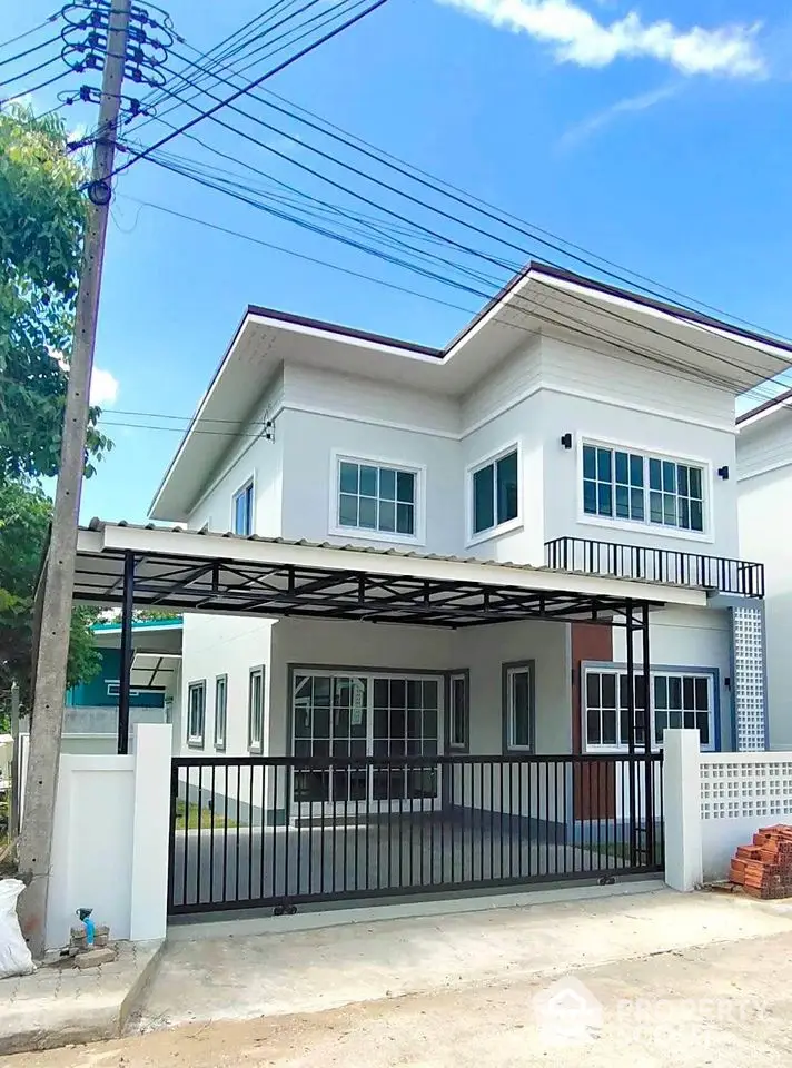 Modern two-story house with sleek design and spacious driveway in a suburban neighborhood.