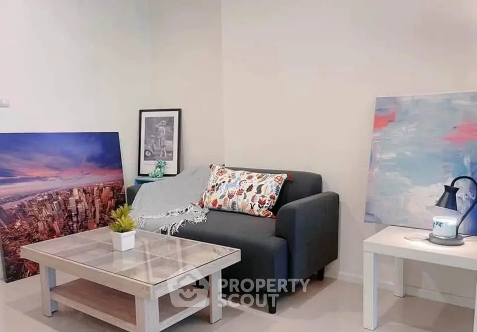 Chic living room with modern sofa, stylish coffee table, and vibrant artwork for a cozy ambiance.