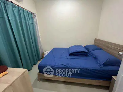 Cozy bedroom with blue bedding and modern wooden furniture