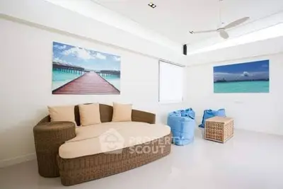 Modern living room with stylish wicker furniture and ocean-themed decor, perfect for relaxation and comfort.
