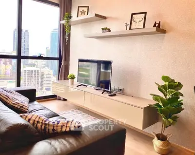Modern living room with city view, sleek furniture, and stylish decor in a high-rise apartment.