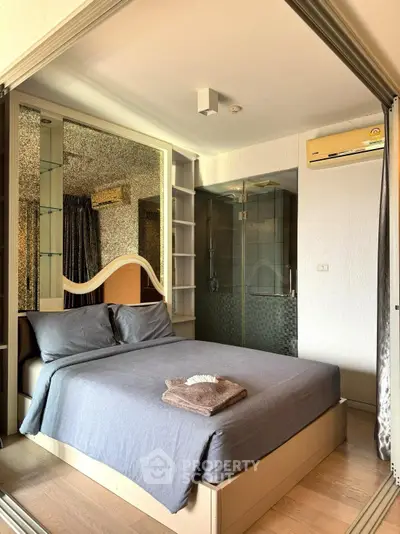 Cozy bedroom with modern decor and ensuite bathroom in a stylish apartment.