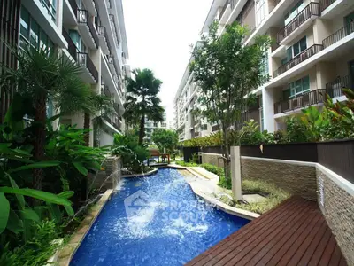 Luxurious condominium with stunning pool and lush garden view